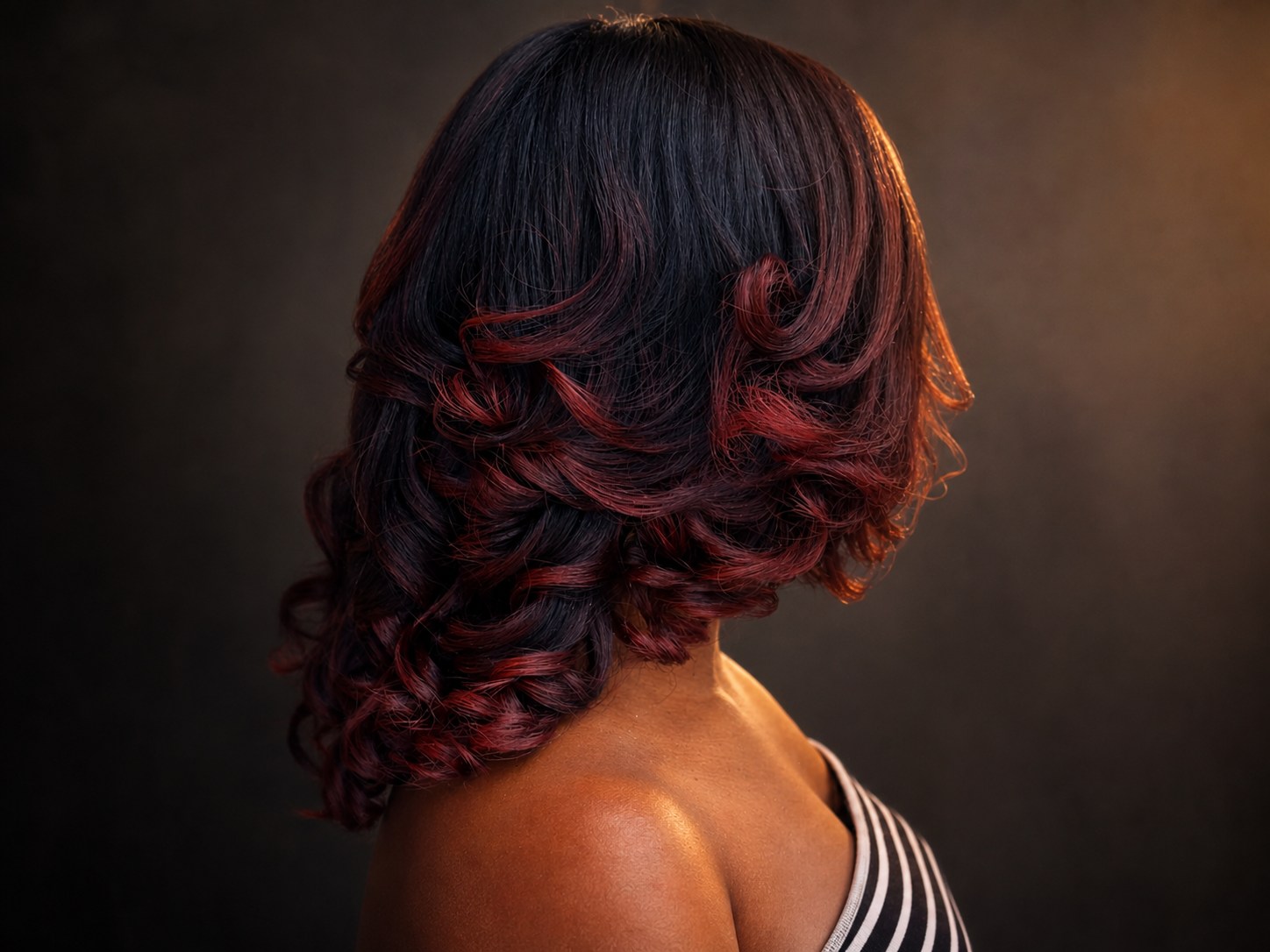 Burgundy layered hairstyle finished by Teddy Chisom