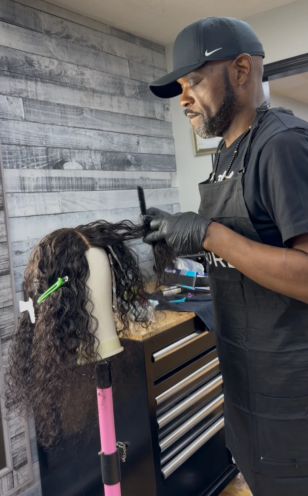 Teddy Chisom coloring a custom wig by hand