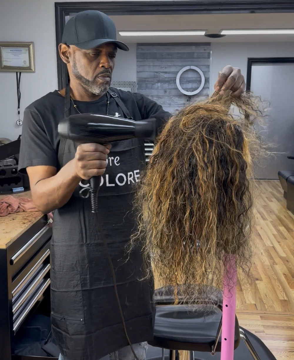 Teddy finishing the curls on a custom wig